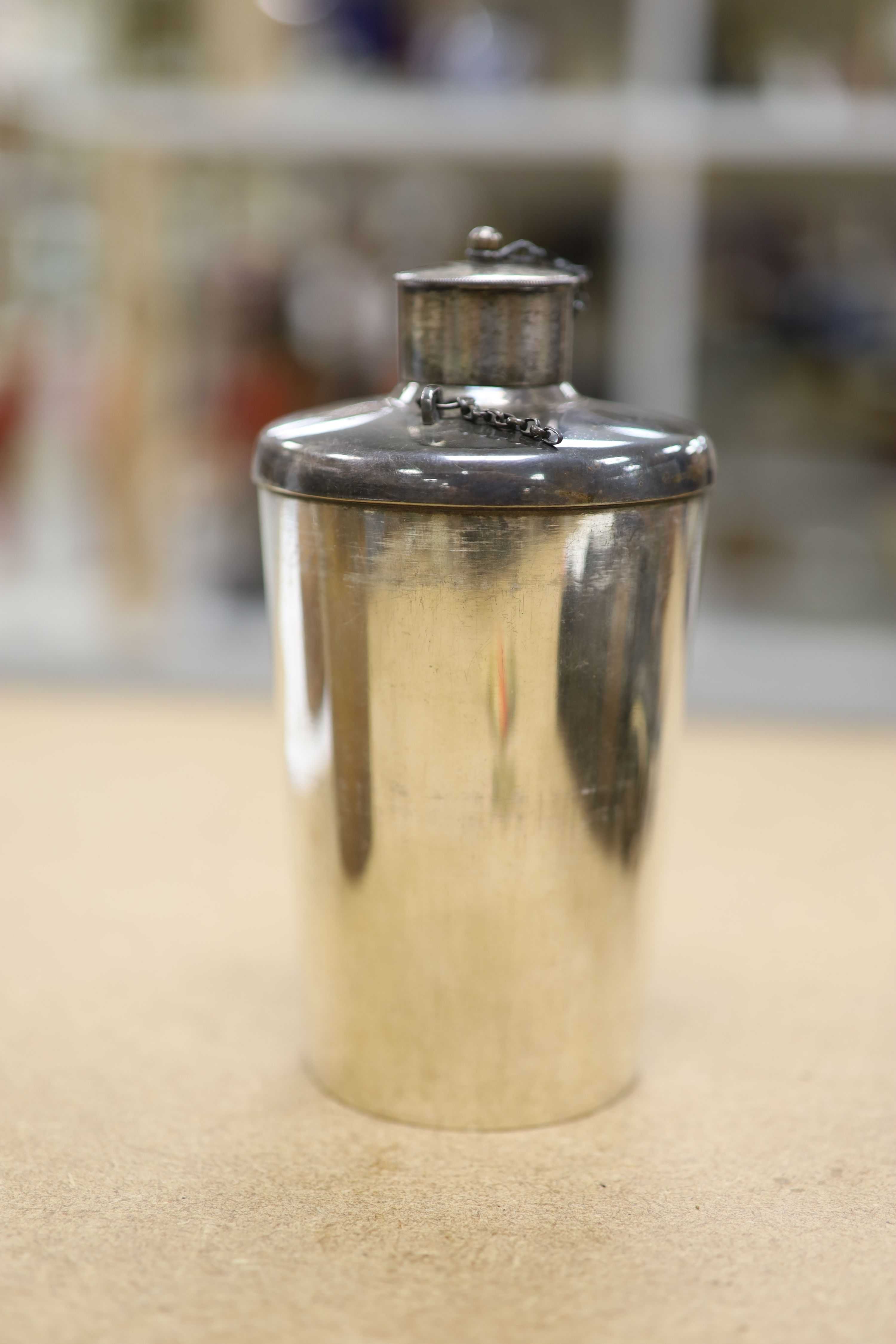 A leather cased flask and cups, various WWI and WWII medals, binoculars and a fishing reel